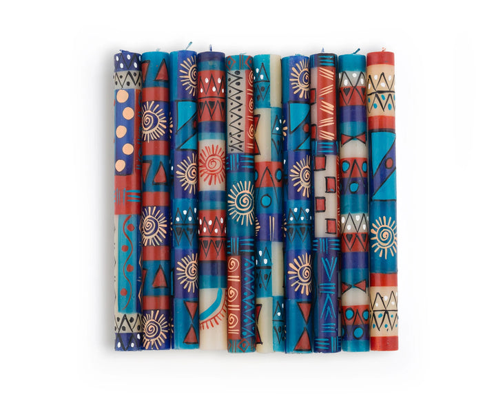 10 African Sky dinner tapers showing the 10 different designs in this collection.  Turquoise, dark blue, cream and dark tan in dots, sunbursts, and geometric designs- very pretty!