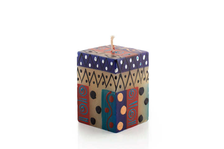 2" x 2" x 3" African Sky cube. Turquoise, dark blue, cream and dark tan in dots, sunbursts, and geometric designs.