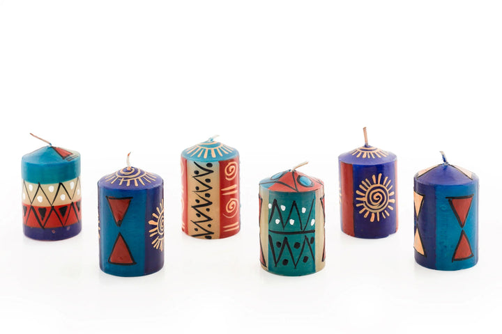 6/ 2" African Sky votives. Turquoise, dark blue, cream and dark tan in dots, sunbursts, and geometric designs. These come packaged in a 6-pack gift box.