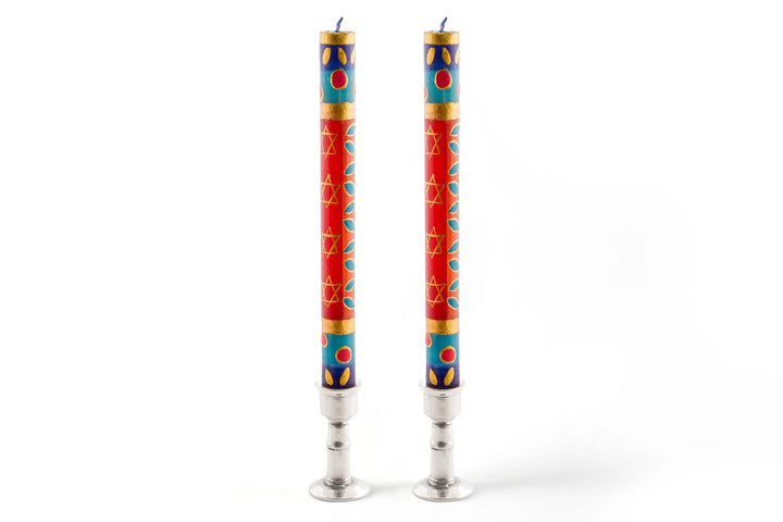 Pair of matched 9" Judaica dinner tapers in pewter taper holders. Rich colors of red, blue, light green, purple & turquoise with touches of gold and star of David intertwined in the design.