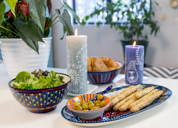 Photo of a table setting with the ceramics and Henna Pillar Candles. - great match! The mini nut bowl in used on the ceramic serving platter to show how well this size works to hold complementary items for the food on the platter.