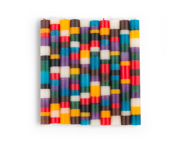 10 Memphis Stripe tapers illustrating the 10 different designs in this candle collection. Handmade and hand painted with stripes of assorted colors, turquoise, golden yellow, burnt orange, purple, dark green, brown & beige. Fair Trade home decor.