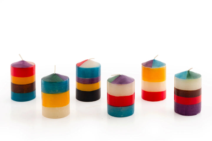 6/ 2" votive candles in Memphis Stripe. Handmade and hand painted with stripes of assorted colors, turquoise, golden yellow, burnt orange, purple, dark green, brown & beige.