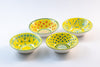 4 'nut' size ceramic bowls with yellow base color.  Dots & Stripes painted on top in orange, jasper green & blue.   