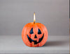 Whimsy Pumpkin candle! Orange with a Jack o' Lantern face painted on in black.   BOO!