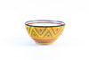 Ceramic serving bowl with base color of orange. Dots & Stripes painted on top in fun colors of jasper green, turquoise, orange & red. White inside the bowl.