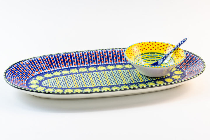 Indigo blue platter with a yellow tiny bowl & spoon sitting on it.   Fun to mix & match the colors.