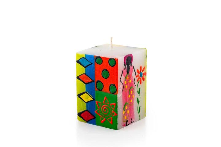 African Ladies 2" x 2" x 3" cube candle. The design has a white background with different African Ladies painted on the sides - with attitude! Each in a colorful frock with arm up or on hips. Fair Trade. 