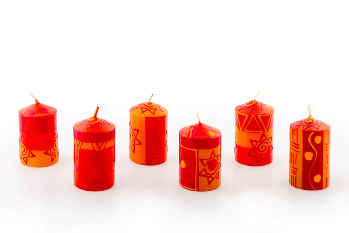 African Sunset 2" votives that come in a 6-pack brown kraft gift box.   Orange & yellow graphic suns and designs. 