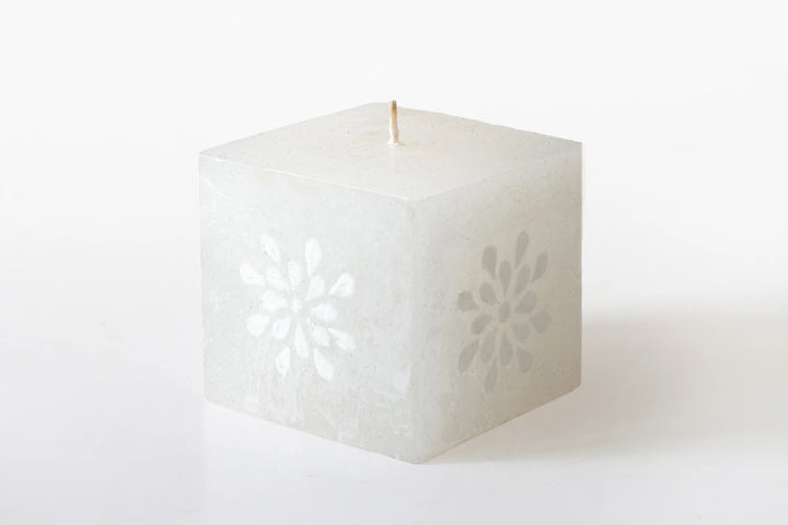 3" x 3" x 3" White on white cube candle. The designs include floral or graphic patterns painted in white on a white candle. Lovely as they burn as the candle lights from within and shows the artistry on the candle.