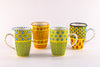 4 Very colorful coffee mugs with yellow base color.  Topped with dots & stripes in turquoise, orange, green, light & indigo blue.  Very fun!